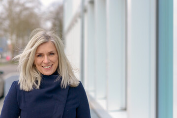 Happy friendly blond woman with tousled long hair