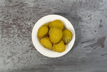 Hamburger dill pickles on a gray table