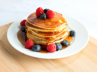 stack of pancakes with raspberries