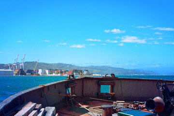 Fototapeta na wymiar Bow of an old floating crane boat in Wellington Harbour on a sunny day. Wellington, New Zealand.