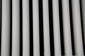 Heating pipes are plastic in the form of several vertical pipes. Construction, background, textures, design.