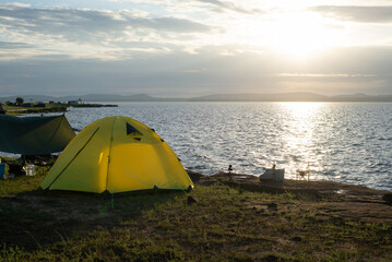 Camping by the sea, Tent on coast at sunrise.