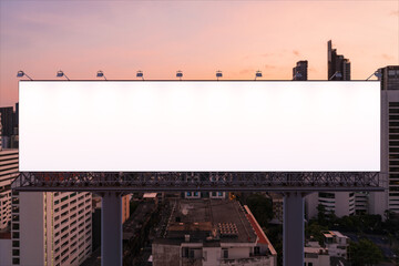 Blank white road billboard with Bangkok cityscape background at night time. Street advertising poster, mock up, 3D rendering. Front view. The concept of marketing communication to promote idea.