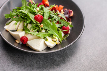 Salad with cottage chese, tomatoes and raspberry