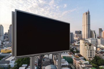 Fototapeta na wymiar Blank black road billboard with Bangkok cityscape background at sunset. Street advertising poster, mock up, 3D rendering. Side view. The concept of marketing communication to promote or sell idea.