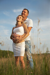 Pregnant happy young couple dreams of the future