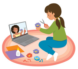 Little girl watching craft tutorial video on a laptop and making paper flowers
