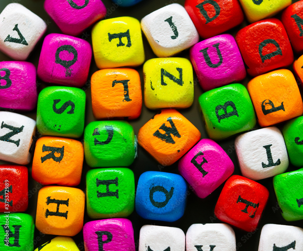 Fototapete colored cubes with letters. multi-colored alphabet macro photography. wooden elements of the game