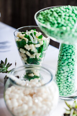 brightly colored candy in jars on table for event