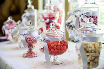 brightly colored candy in jars on table for event