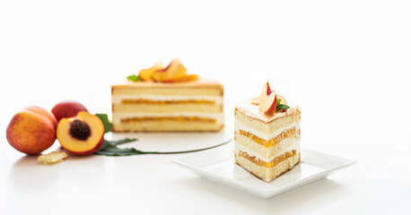 Half or slice of delicious fresh cake on white background. Peach sponge cake