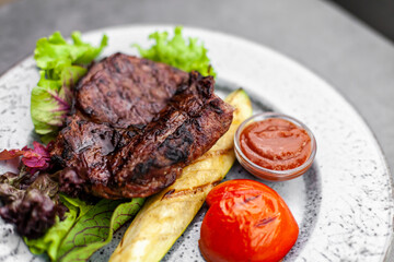 fried steak and grilled vegetables