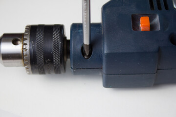Disassembles a hand held electric drill on a white background