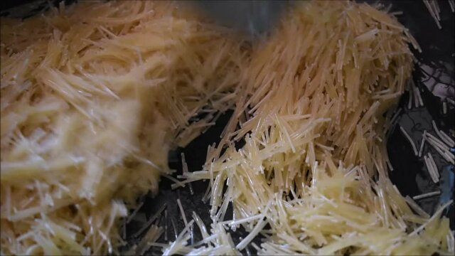 Roasting semiya or Vermicelli in ghee for making samiya payasam. Payasam is a south Indian dessert most commonly found in Kerala.