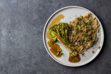 roasted broccoli with quinoa and pomegranate sauce. Top view. Copy space