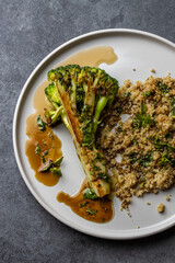 roasted broccoli with quinoa and pomegranate sauce. Top view