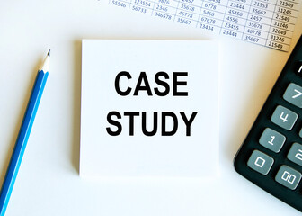 Notepad with text CASE STUDY on a white background, near calculator and office supplies. Business concept.