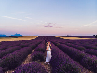 Satisfied lady traveler walking on lavender fields