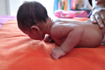 head holding exercise posture of a infant baby during tummy time