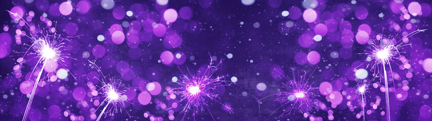 Silvester / new year background banner panorama long- Purple firework sparklers in the dark blue...