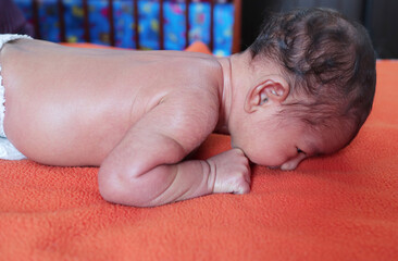 head holding exercise posture of a infant baby during tummy time.view from right