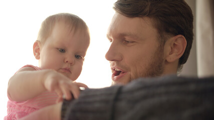 Bearded dad kissing baby. Father time concept. Baby touching wrist watch