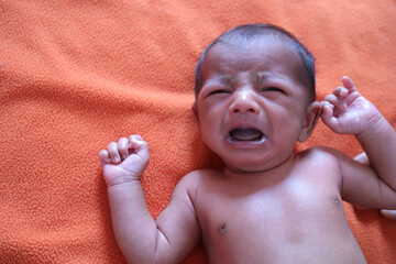 an infant crying in pain and distress.