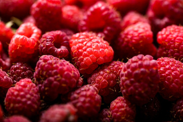 Fresh and sweet red raspberries texture. fruit pile background