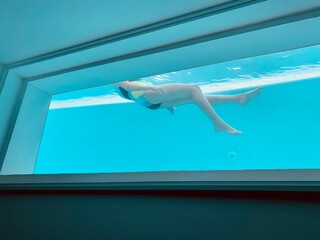 girl jumping in pool swimming