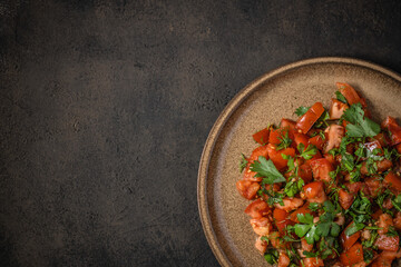 Fresh tomato salad with parsley, coriander, dill, spring onion and ground cumin. Moroccan tomato salad. Top view. Copy space
