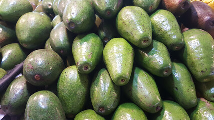 Avocados are stacked on top of each other.