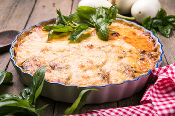 Musaka close-up side view. Traditional Greek dish of baked layers, eggplant, meat, Bechamel sauce
