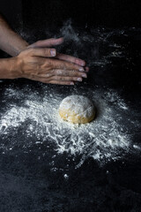 Pizza dough. Making dough by hands at bakery or at home.Preparation of the dough