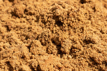 wet yellow sand with traces of raindrops on the setting sun close-up with a blurred background. as a natural background for the designer