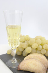 Glass of cava, lucky grapes and Christmas sweets. Copy space