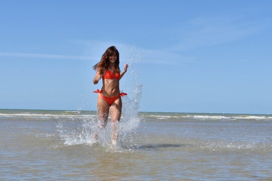 Magnifique femme qui court sur la plage