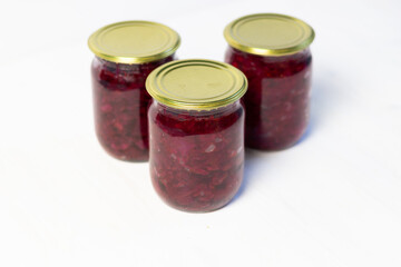 Ingredients for borscht in glass jar as preserves on white background 