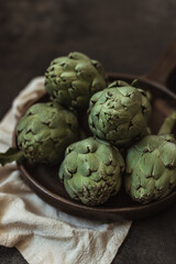 Fototapeta premium Fresh green artichokes. Top view. Copy space