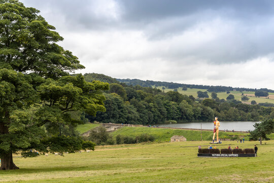 Scenic landscape at Yorkshire Sculpture Park with Damien Hurst monumental sculpture The Virgin Mother in background.