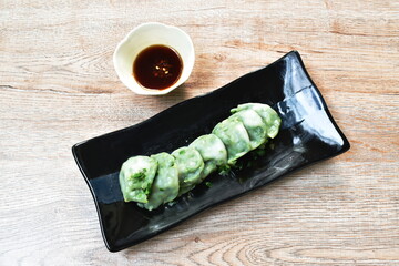 steamed Chinese rice flour dumpling stuffed fried chop garlic chives on plate dipping soy sauce