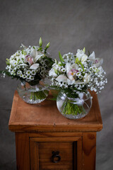 First holy communion flower bouquets. White candle decorated with orchid and flowers white flowers.