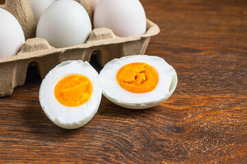 White duck eggs and salted egg food on a wooden table