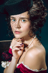 Love tragic. Young woman as Anna Karenina isolated on dark blue background. Retro style, comparison of eras concept. Beautiful female model like literature character, great, old-fashioned.