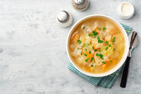 Homemade cabbage soup in bowl on concrete background