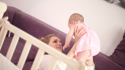 Beautiful mom playing with baby. Carefree family. Cheerful woman happy with baby