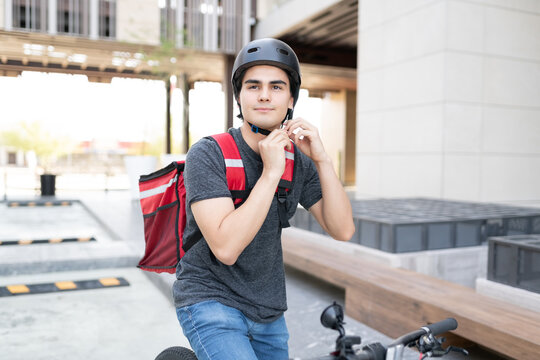 Delivery Man Wearing Helmet On Bicycle
