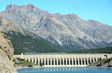 Obraz na płótnie Canvas Lake Cancano is an artificial water basin adjacent to Lake San Giacomo near Bormio. The Cancano dam is an engineering project to produce hydroelectric energy. 