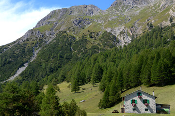 Fototapeta na wymiar picturesque mountain house on the Alps near Lake San Giacomo in the Fraele valley in the municipality of Valdidentro near Bormio. 
