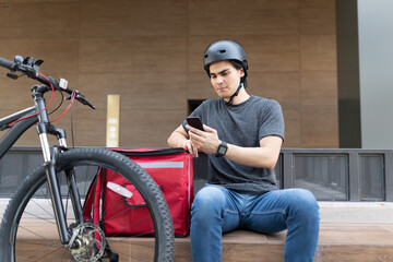 Hispanic Delivery Man Using Mobile Phone