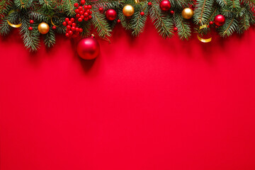 Christmas red background with christmas decorations, top view with space for text.